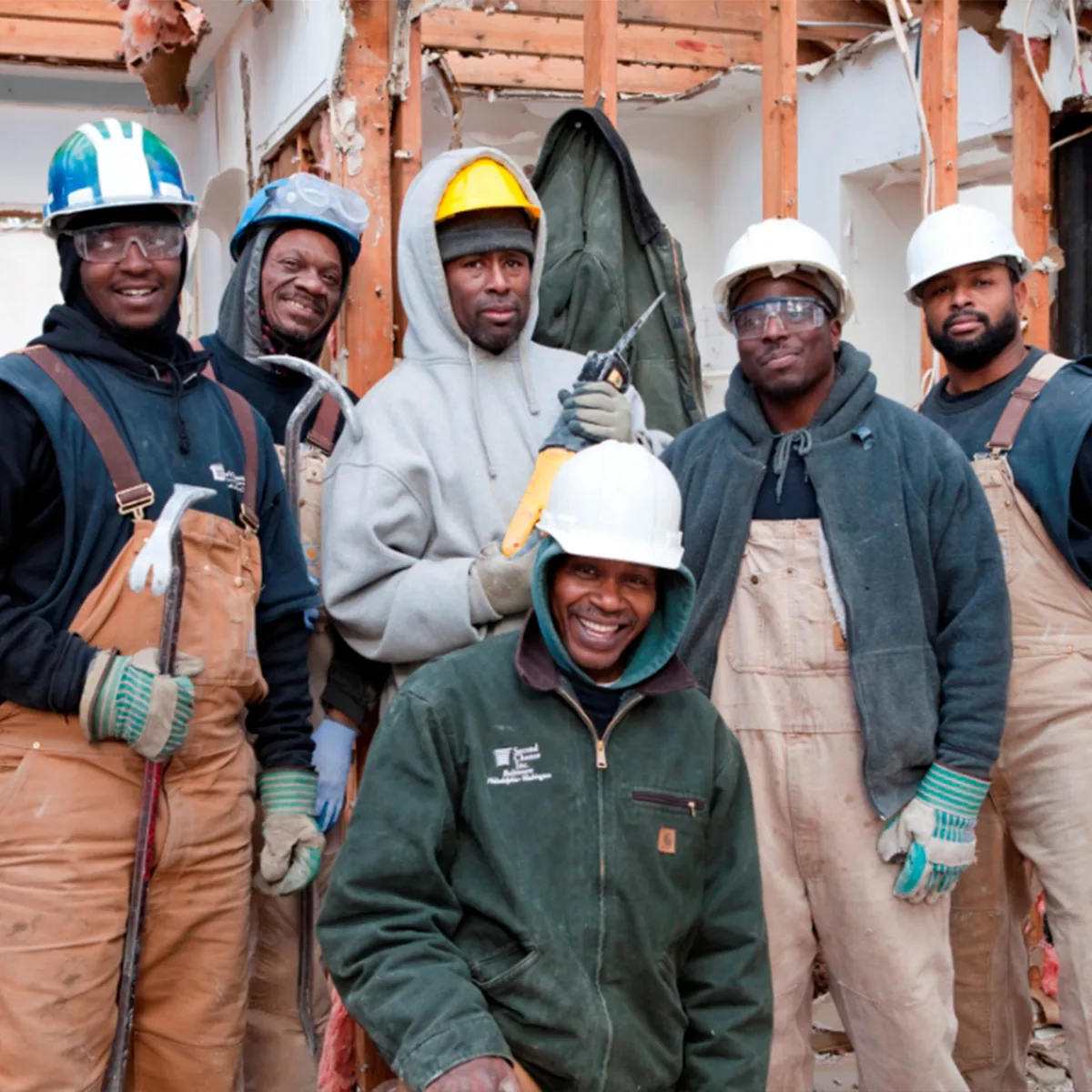 Smiling team of Second Chance, Inc. workers salvaging used building materials and reclaimed wood in Baltimore. This non-profit provides unique, sustainable, and affordable home improvement items.